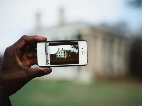A person takes a photo of the Addison Gallery of Contemporary Art on an iPhone.