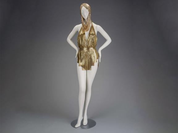 Photo of female mannequin wearing a two-piece gold metallic bathing suit.
