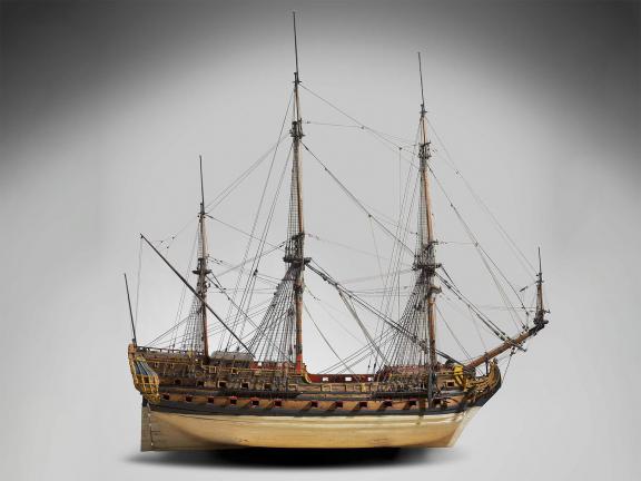 Photograph of a large wooden ship model with three masts.