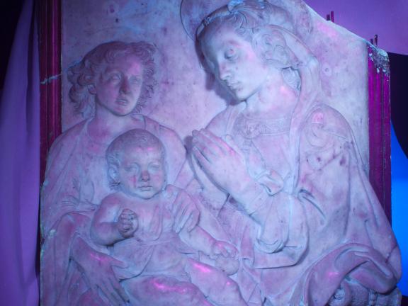 The marble relief Virgin Adoring the Child under ultraviolet light.
