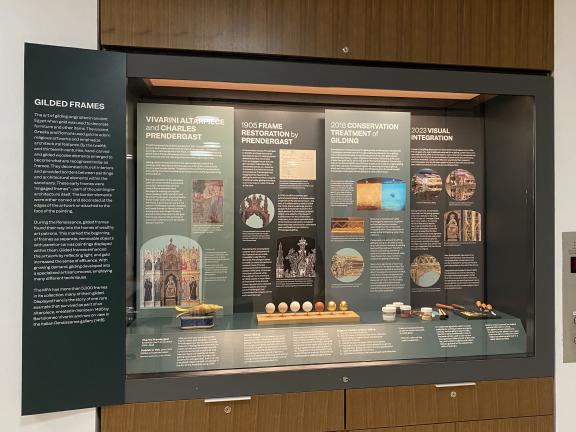 A display case showing the different stages of water gilding, along with various gilding materials and tools