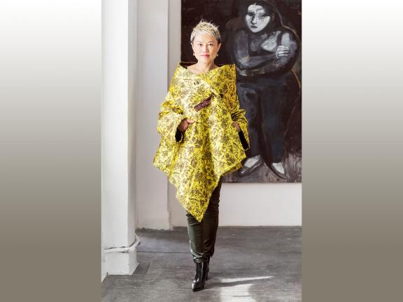 Woman wearing colorful yellow wrap designed by Han Feng
