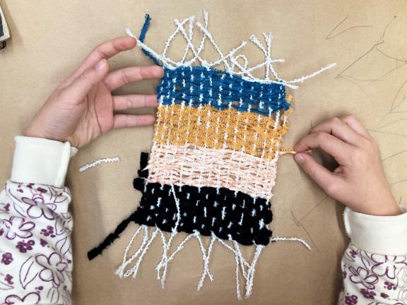 weaving with hands made by young student 