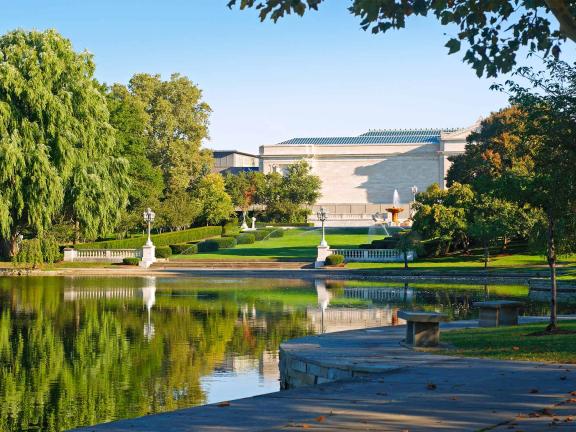 The Cleveland Museum of Art and trees reflected in Wade Lagoon.