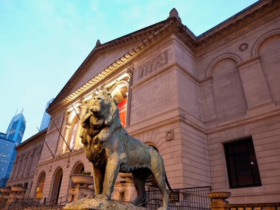 The façade of the Art Institute of Chicago at dusk.