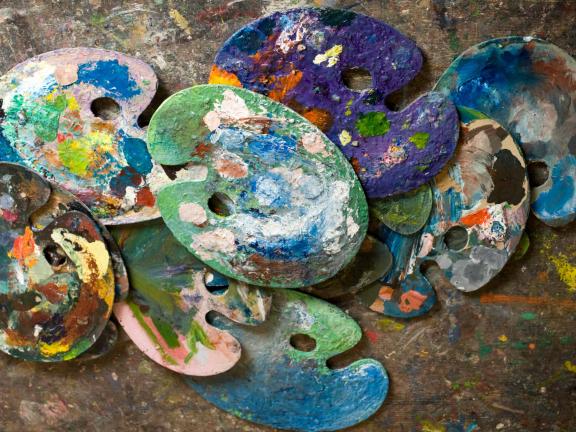 Arrangement of messy paint palettes