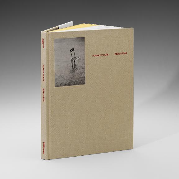 Image of book covered in a tan cloth. The title, Robert Frank: Mary's Book is in red. A small photo of a chair is in the upper left corner. 