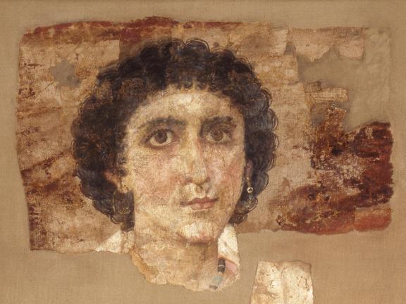 An image of the head of a young person on linen. 