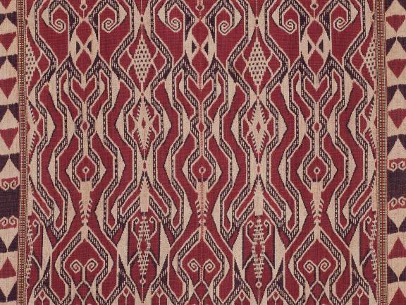 A reddish-brown, tan, and black rectangular patterned cloth.