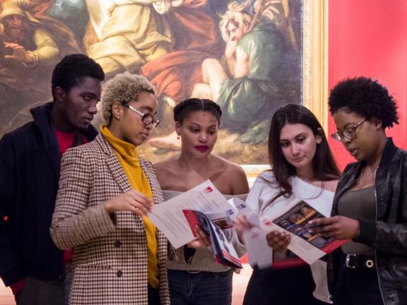 People in galleries looking at map, group of students