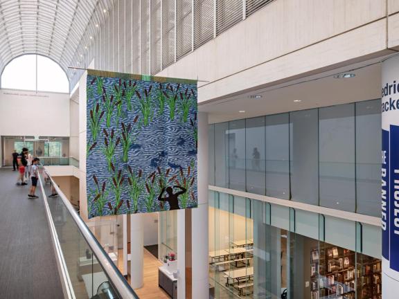 An installation photograph of Diedrick Brackens's hanging tapestry, visitation.
