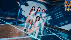 Members of female k-pop group, aespa pose in white and sparkly outfits for a promotional photo