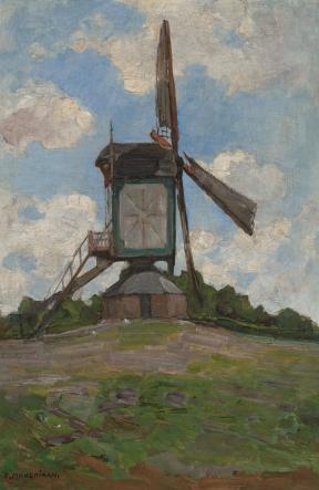 A three-sailed windmill spins at the top of a small hill. 