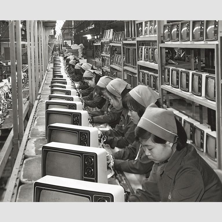 A group of women work on a television production line for Samsung.