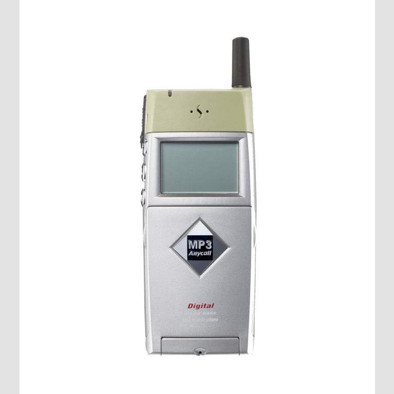 A gray and silver cell phone with small screen on the front and a short antenna.
