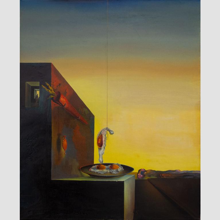 A building at sunset has a large carrot affixed to its side; two eggs on a plate sit on the building white one egg hangs above the plate from a string.