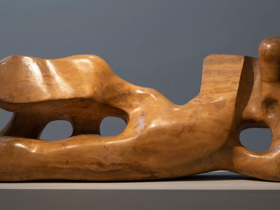 Wooden sculpture that abstractly resembles a reclining figure