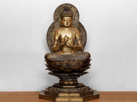 A wood and gold sculpture of Sainchi, the Buddha of Infinite illumination. 