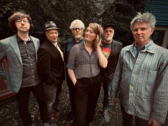 The five members of the band Session Americana pose with guest performer Eleanor Buckland.