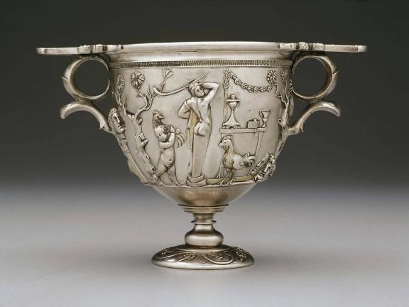 A Roman two-handled silver cup with Bacchic scene. 