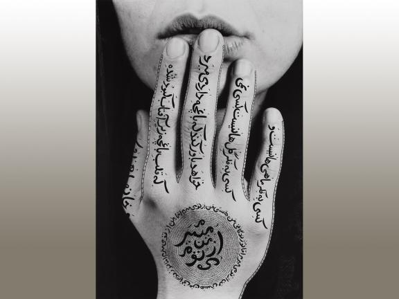 Black and white photograph of a close up of a woman's face and hand.
