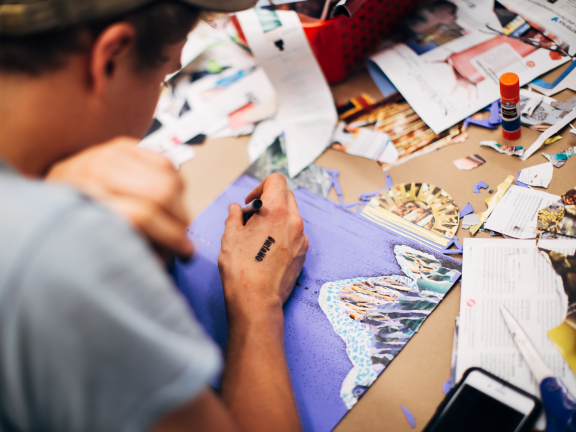 male student creating collage
