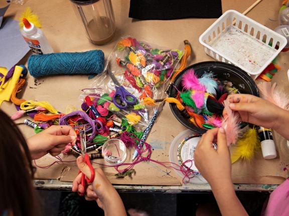Young students gathering embroidery thread for project (SAC)